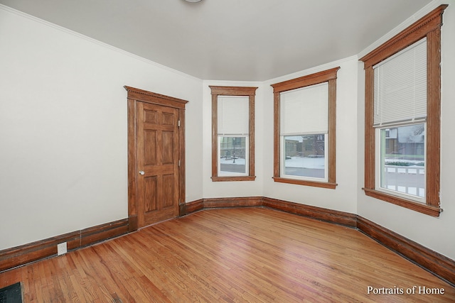 127 N W St, Wheaton, IL 60187 - empty room featuring light wood-style floors, healthy amount of natural light, and ornamental molding