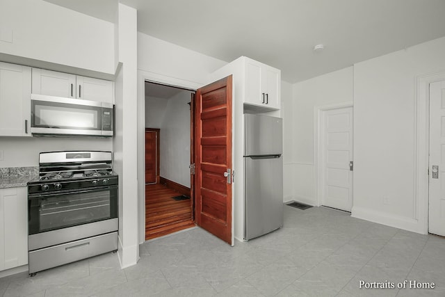 127 N W St, Wheaton, IL 60187 - kitchen with stainless steel appliances, white cabinetry, and light stone countertops