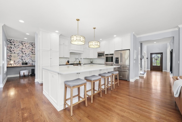 13616 S Erin Dr, Homer Glen, IL 60491 - kitchen featuring appliances with stainless steel finishes, wood finished floors, light countertops, crown molding, and white cabinetry