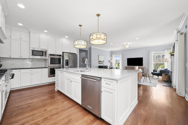 13616 S Erin Dr, Homer Glen, IL 60491 - kitchen with appliances with stainless steel finishes, light wood finished floors, open floor plan, tasteful backsplash, and ornamental molding
