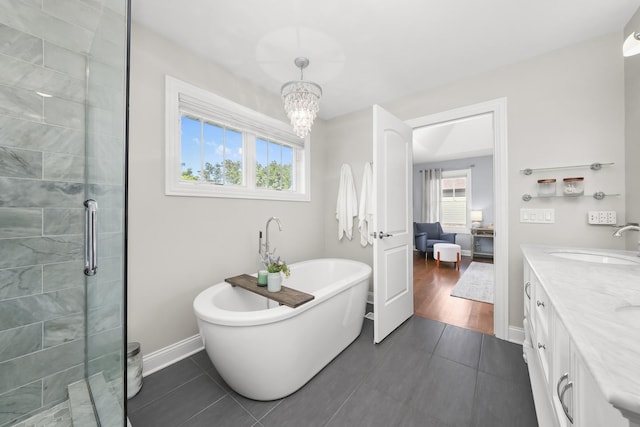 13616 S Erin Dr, Homer Glen, IL 60491 - bathroom with a freestanding bath, tile patterned floors, tiled shower, double vanity, and a chandelier