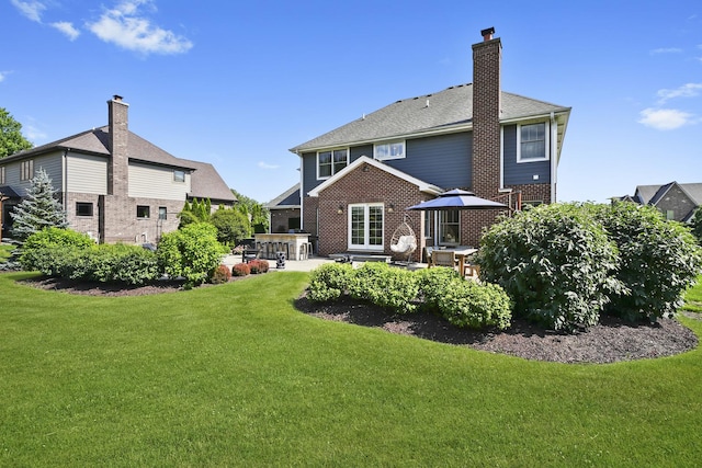 13616 S Erin Dr, Homer Glen, IL 60491 - back of property with a patio area, a lawn, brick siding, and a chimney