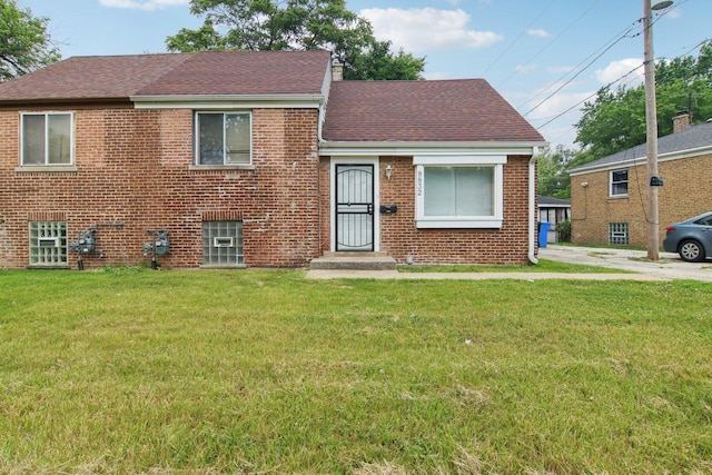 9832 S Oglesby Ave, Chicago, IL 60617 - view of front of house with a shingled roof, a front lawn, and brick siding