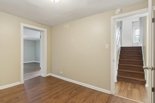 9832 S Oglesby Ave, Chicago, IL 60617 - spare room featuring dark wood-style floors, stairway, and a smoke detector