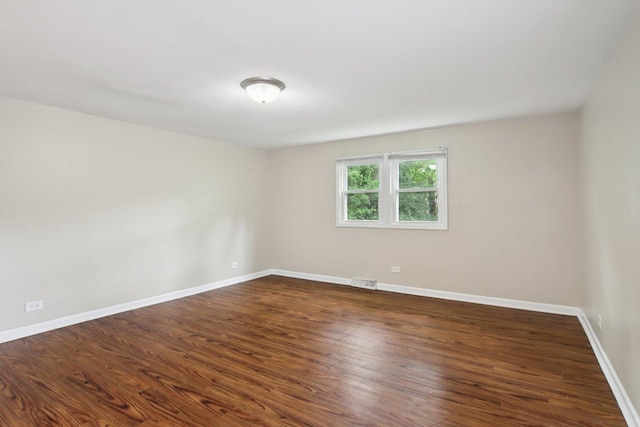 9832 S Oglesby Ave, Chicago, IL 60617 - spare room with baseboards and dark wood-style floors