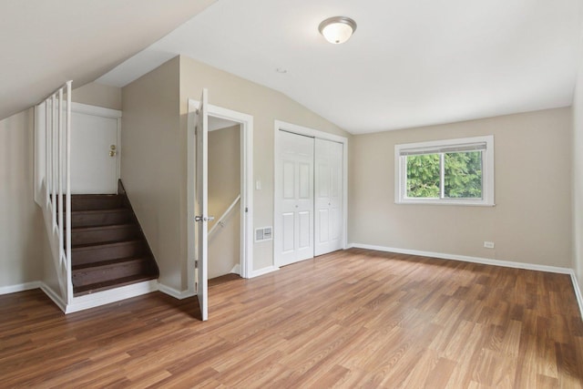 9832 S Oglesby Ave, Chicago, IL 60617 - unfurnished bedroom featuring vaulted ceiling, light wood-type flooring, and a closet