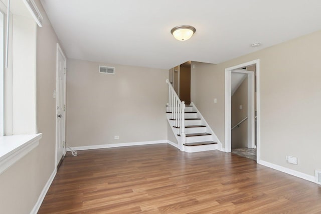 9832 S Oglesby Ave, Chicago, IL 60617 - unfurnished room with stairs, wood finished floors, and a smoke detector