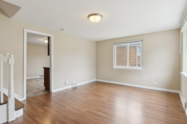 9832 S Oglesby Ave, Chicago, IL 60617 - unfurnished room with wood finished floors, stairway, and a smoke detector