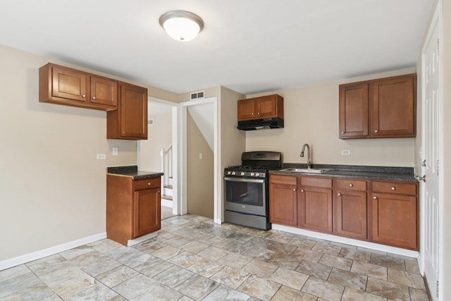 9832 S Oglesby Ave, Chicago, IL 60617 - kitchen with gas stove, under cabinet range hood, and brown cabinets