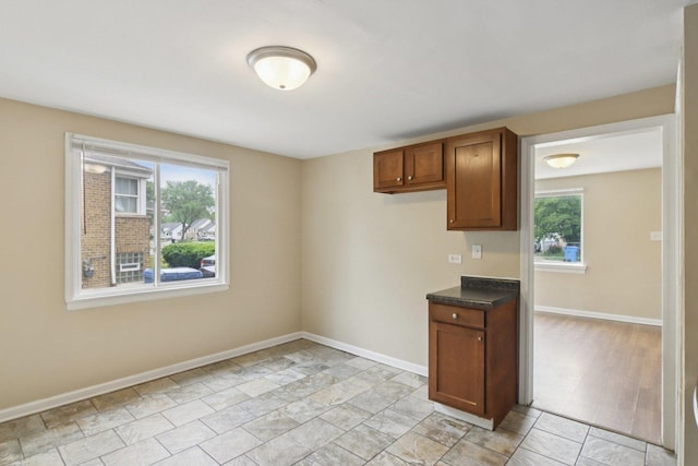 9832 S Oglesby Ave, Chicago, IL 60617 - kitchen featuring dark countertops and brown cabinetry