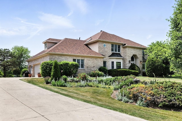 14N924 White Pines Ln, Hampshire, IL 60140 - view of front facade featuring an attached garage, a shingled roof, a front lawn, brick siding, and concrete driveway