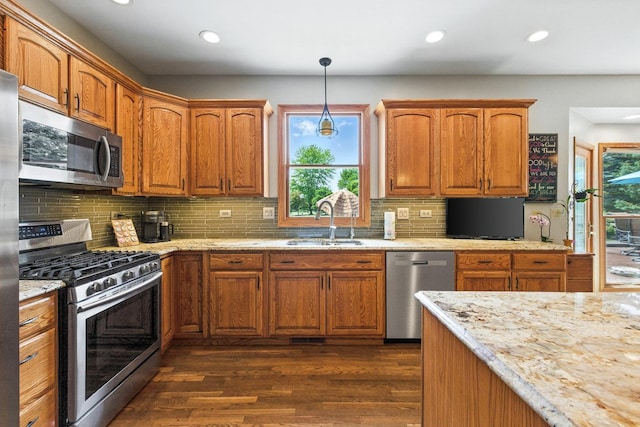 14N924 White Pines Ln, Hampshire, IL 60140 - kitchen with appliances with stainless steel finishes, dark wood-style floors, recessed lighting, backsplash, and brown cabinetry