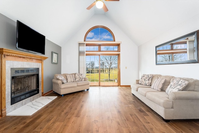 17707 W 113th Hwy, Custer Park, IL 60481 - living area featuring a tile fireplace, high vaulted ceiling, a ceiling fan, wood finished floors, and healthy amount of natural light