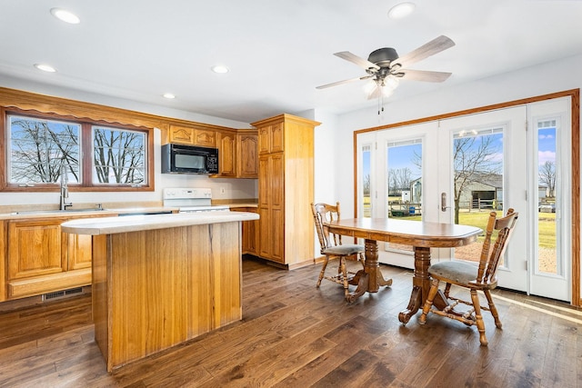 17707 W 113th Hwy, Custer Park, IL 60481 - kitchen with black microwave, white electric range oven, light countertops, a center island, and recessed lighting