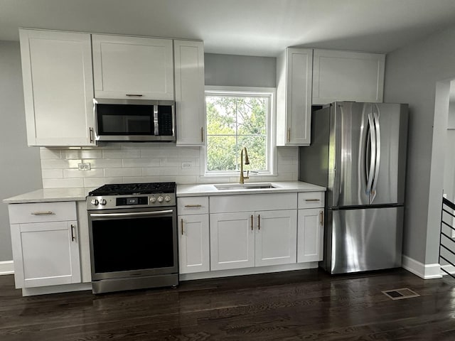 2212 N 2829th Rd, Marseilles, IL 61341 - kitchen featuring stainless steel appliances, light countertops, dark wood-style flooring, and decorative backsplash