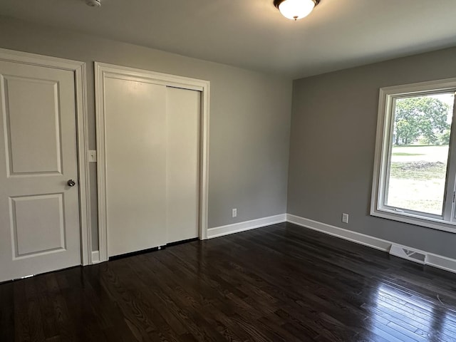 2212 N 2829th Rd, Marseilles, IL 61341 - unfurnished bedroom with dark wood-style floors and a closet