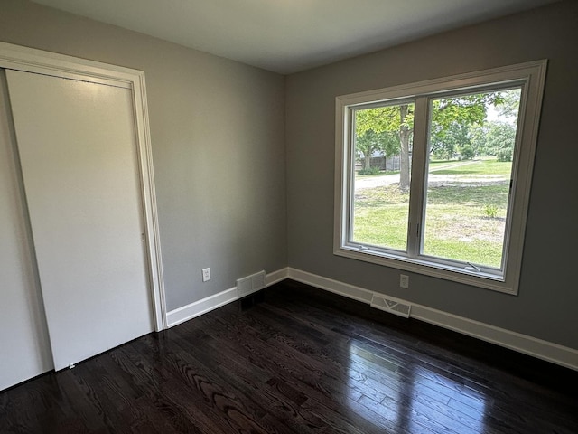 2212 N 2829th Rd, Marseilles, IL 61341 - unfurnished bedroom with dark wood-type flooring and baseboards