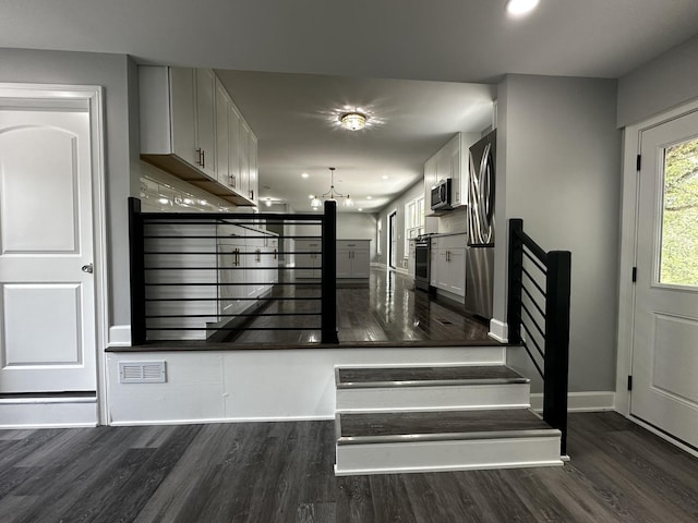 2212 N 2829th Rd, Marseilles, IL 61341 - stairs featuring wood finished floors and a chandelier