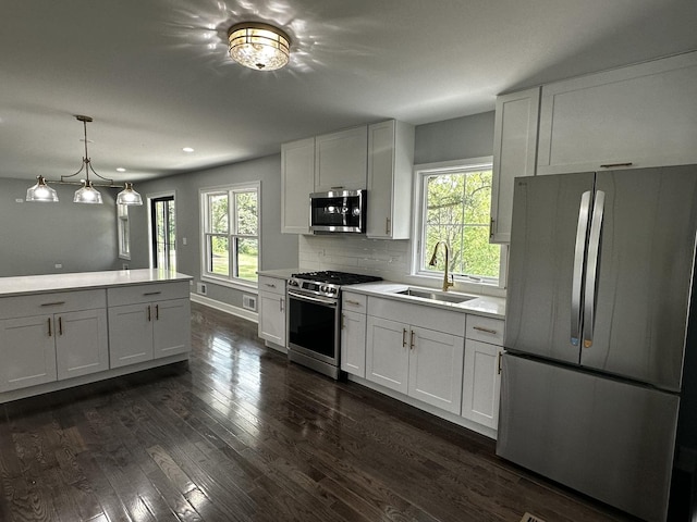 2212 N 2829th Rd, Marseilles, IL 61341 - kitchen featuring stainless steel appliances, light countertops, dark wood-style flooring, backsplash, and white cabinets
