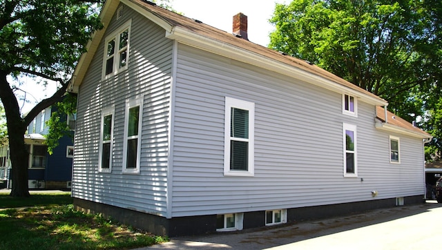 459 Talma St, Aurora, IL 60505 - view of home's exterior with a chimney