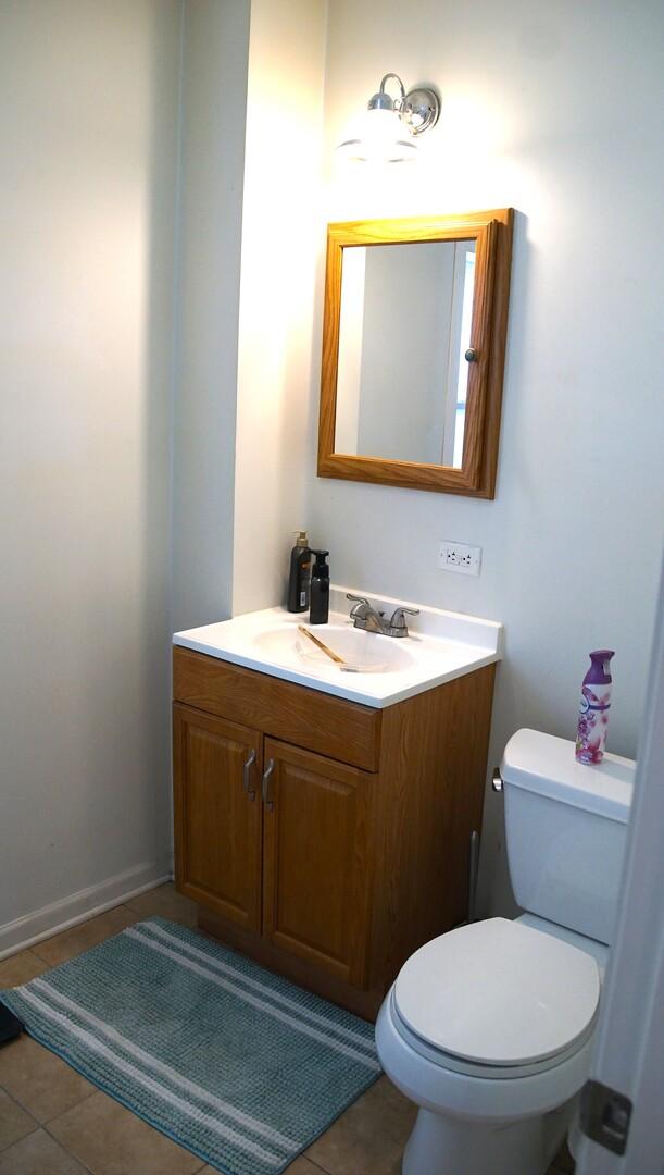 459 Talma St, Aurora, IL 60505 - half bathroom with vanity and tile patterned floors