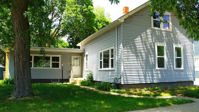 459 Talma St, Aurora, IL 60505 - view of front facade featuring entry steps, a chimney, and a front lawn
