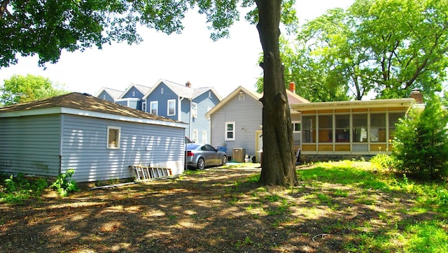 459 Talma St, Aurora, IL 60505 - back of house with a sunroom and an outbuilding