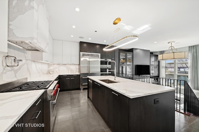 417 E N Water St, Chicago, IL 60611 - kitchen with premium appliances, modern cabinets, decorative backsplash, hanging light fixtures, and a kitchen island with sink