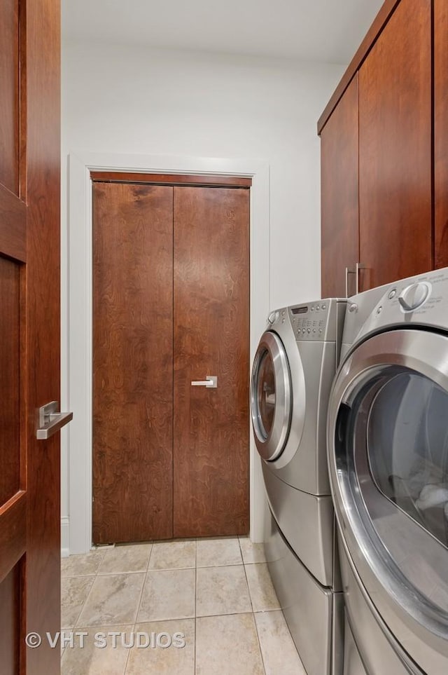 417 E N Water St, Chicago, IL 60611 - laundry room with cabinet space, washing machine and clothes dryer, and light tile patterned floors