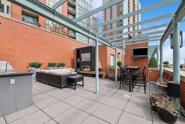 417 E N Water St, Chicago, IL 60611 - view of patio featuring an outdoor living space with a fireplace, a pergola, and an outdoor kitchen