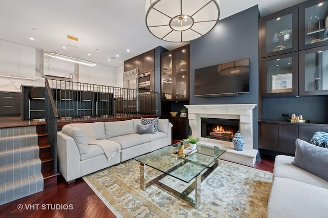 417 E N Water St, Chicago, IL 60611 - living area with dark wood finished floors, a high end fireplace, stairs, and recessed lighting