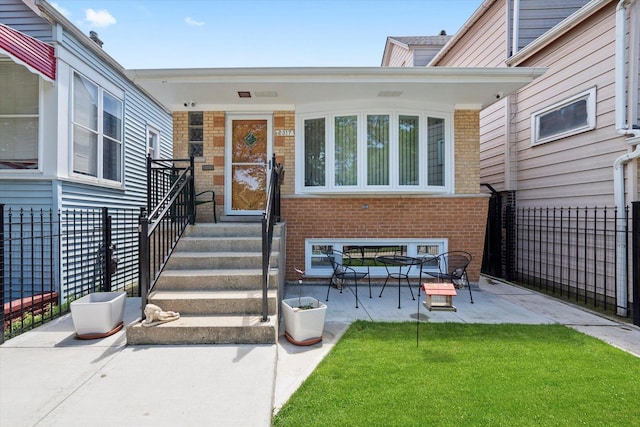 2317 W 50th St, Chicago, IL 60609 - doorway to property featuring brick siding, a security system, and a patio area