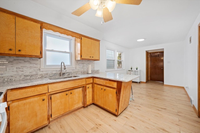 2317 W 50th St, Chicago, IL 60609 - kitchen with a peninsula, tasteful backsplash, light wood-style flooring, and ceiling fan