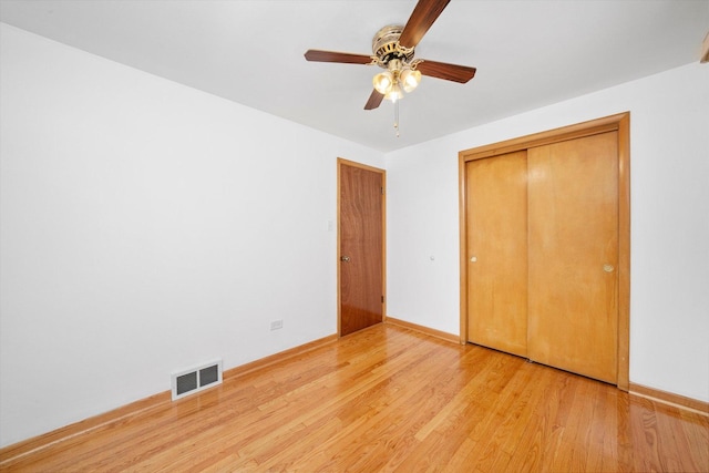2317 W 50th St, Chicago, IL 60609 - unfurnished bedroom with wood finished floors, a closet, and ceiling fan