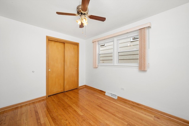 2317 W 50th St, Chicago, IL 60609 - unfurnished bedroom featuring light wood finished floors, a closet, and a ceiling fan