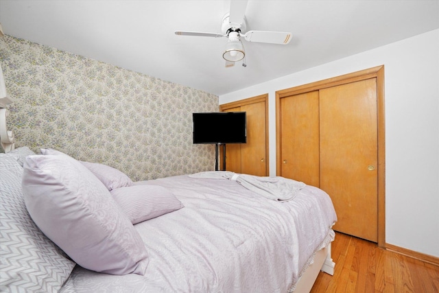 2317 W 50th St, Chicago, IL 60609 - bedroom with two closets, light wood finished floors, ceiling fan, and an accent wall