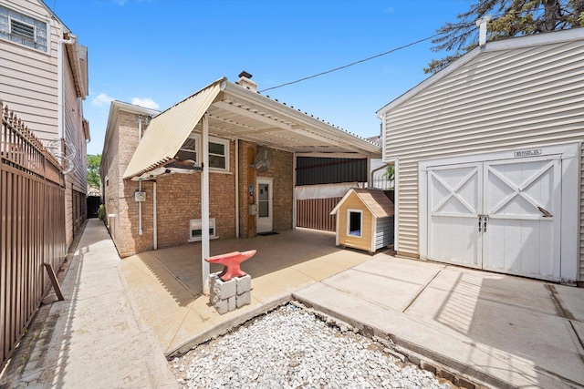 2317 W 50th St, Chicago, IL 60609 - back of house with a storage shed, a fenced backyard, a patio, and a chimney