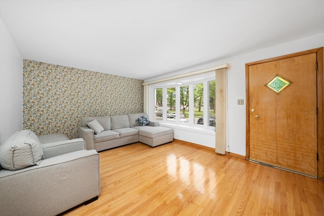 2317 W 50th St, Chicago, IL 60609 - living room featuring wallpapered walls, an accent wall, and light wood finished floors