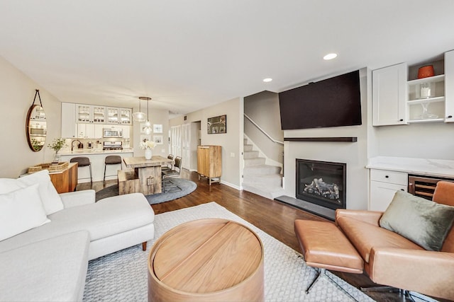 2743 N Wayne Ave Unit B, Chicago, IL 60614 - living area with dark wood finished floors, a glass covered fireplace, recessed lighting, wine cooler, and stairs