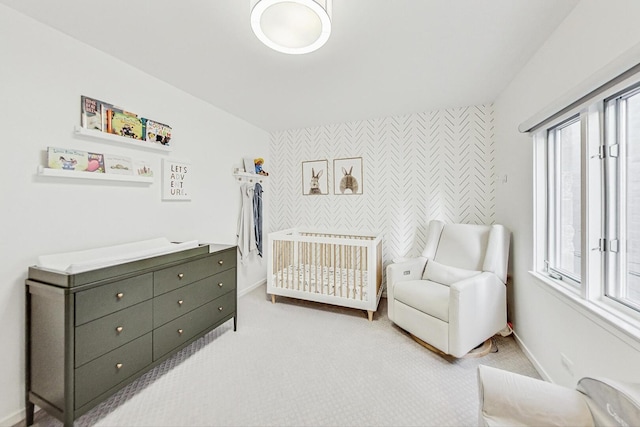 2743 N Wayne Ave Unit B, Chicago, IL 60614 - bedroom featuring an accent wall, multiple windows, wallpapered walls, a nursery area, and light colored carpet