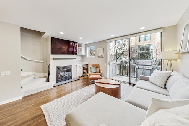 2743 N Wayne Ave Unit B, Chicago, IL 60614 - living area with wine cooler, wood finished floors, a glass covered fireplace, stairs, and recessed lighting