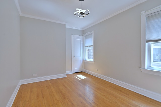 7851 W Cressett Dr, Elmwood Park, IL 60707 - empty room with light wood finished floors, ornamental molding, and a chandelier