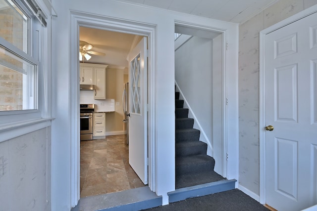 7851 W Cressett Dr, Elmwood Park, IL 60707 - staircase featuring a ceiling fan, stone finish floors, wallpapered walls, and ornamental molding