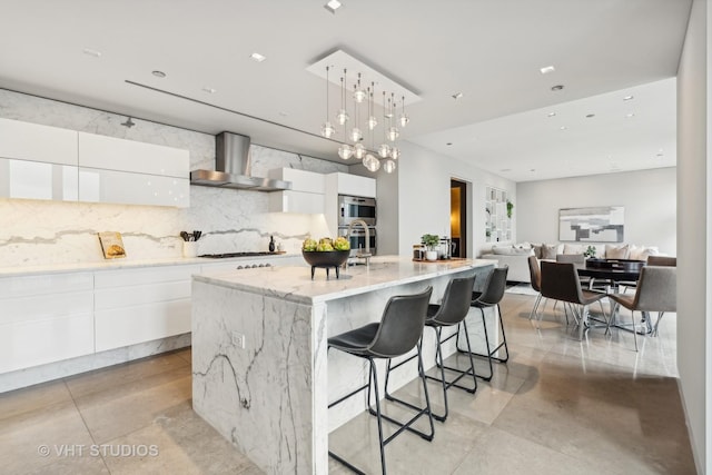 11 E Walton St Unit 4902, Chicago, IL 60611 - kitchen featuring wall chimney exhaust hood, modern cabinets, and white cabinets