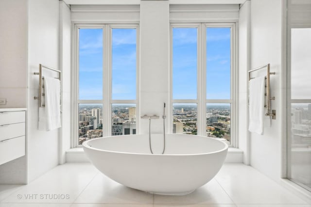 11 E Walton St Unit 4902, Chicago, IL 60611 - bathroom with a soaking tub, a city view, tile patterned flooring, and vanity