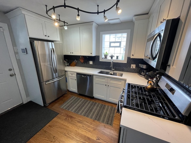 3401 W Beach Ave, Chicago, IL 60651 - kitchen featuring stainless steel appliances, backsplash, dark wood finished floors, and white cabinetry