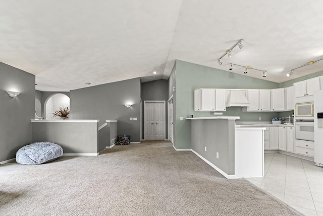 6072 Nimtz Ct, Loves Park, IL 61111 - kitchen featuring open floor plan, lofted ceiling, white cabinetry, rail lighting, and light countertops