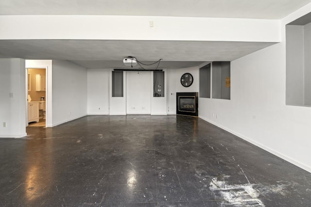 6072 Nimtz Ct, Loves Park, IL 61111 - unfurnished living room featuring a glass covered fireplace and baseboards