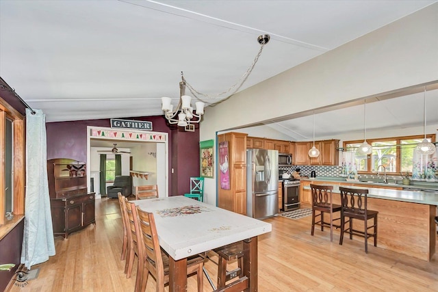944 E County Line Rd, Beecher, IL 60401 - dining area with lofted ceiling, a chandelier, and light wood-type flooring