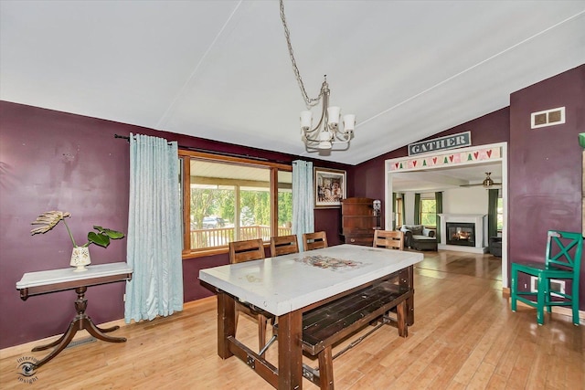 944 E County Line Rd, Beecher, IL 60401 - dining space featuring a chandelier, healthy amount of natural light, lofted ceiling, and light wood-type flooring